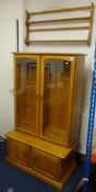 Modern Ercol style glass cabinet, two sections, 92cm wide also a wall hanging shelf