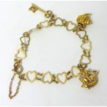 A 9ct gold charm bracelet of heart design with three charms, 7.20g