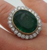 Emerald and diamond oval cluster ring comprising large central oval cut emerald, weight 13.84