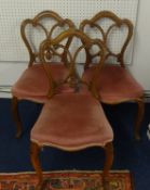 Set of six Victorian dining chairs with walnut frames with carved back rails, stuffed over