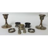 Pair of short silver candlesticks, 10cm , five silver napkin rings, 1.5oz and two plated thimbles (