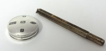 A silver pill box and knife