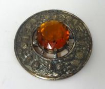 Large Scottish brooch decorated with thistle and large centre 'Citrine' type stone