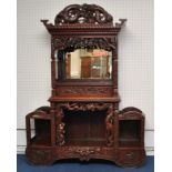 A Chinese cabinet, carved throughout with stylised  bamboo planets, water lilies and dragon's,