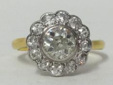 A thirteen stone round diamond cluster ring with old cut diamonds, centre stone .87ct, overall