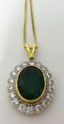 Emerald and diamond oval cluster pendant comprising central large oval cut emerald, weight 4.76