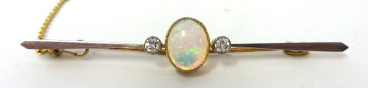 Antique 18 carat gold and platinum opal with one old cut diamond set either side mounted in