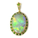 Antique opal pendant with a border of emeralds and diamonds set in yellow metal, approximately