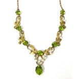 An Edwardian 15ct gold, peridot and seed pearl necklace, set with round peridot and seed pearls,