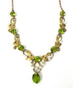 An Edwardian 15ct gold, peridot and seed pearl necklace, set with round peridot and seed pearls,