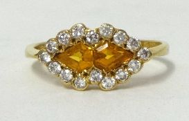 A yellow sapphire and diamond double heart style ring circa 1985, 18ct with copy of insurance
