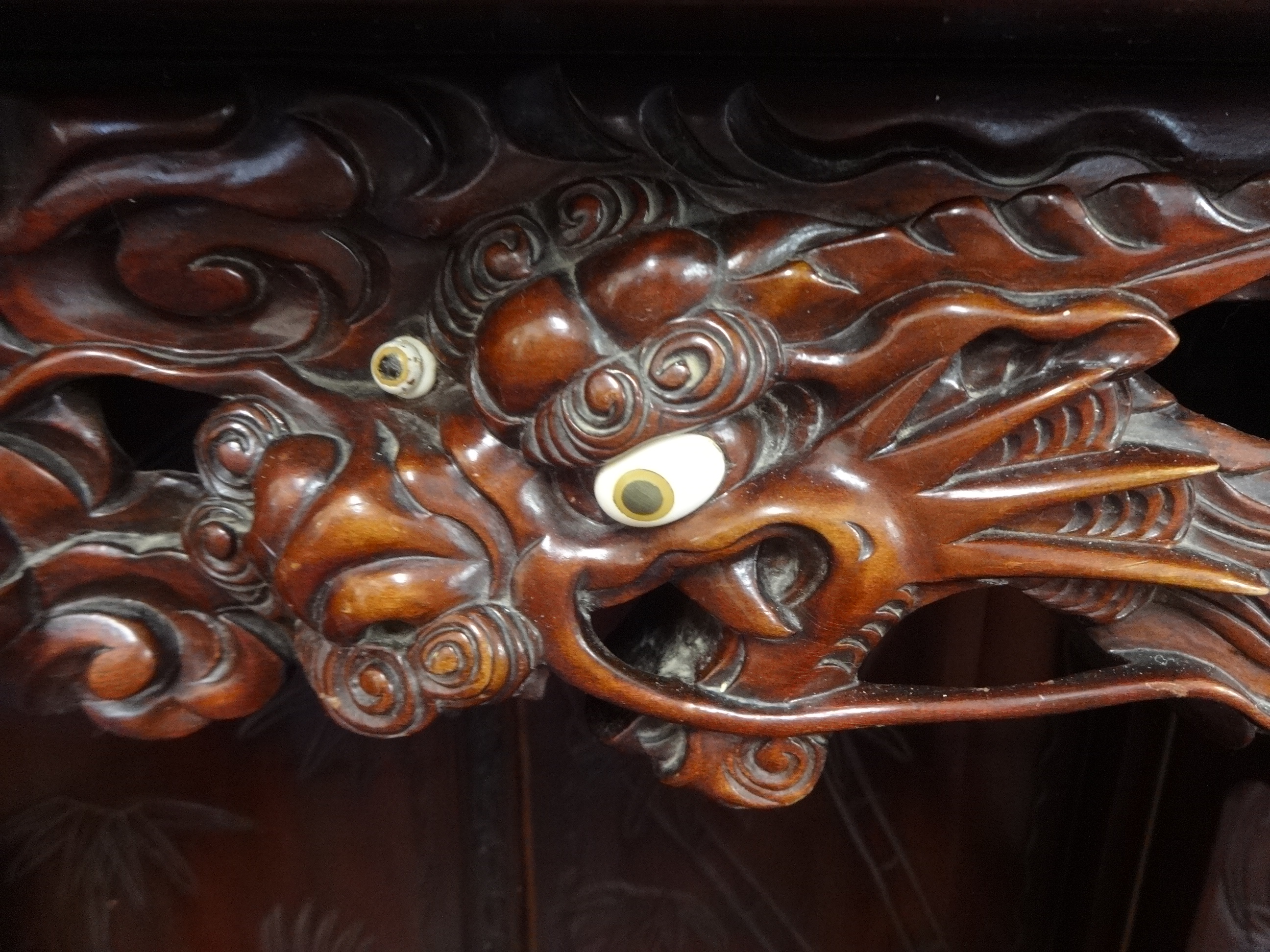 A Chinese cabinet, carved throughout with stylised  bamboo planets, water lilies and dragon's, - Image 4 of 4