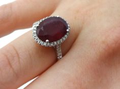 Ruby and diamond oval cluster ring comprising central oval cut ruby weight 5.33 carats surrounded by