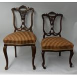 A pair of carved mahogany drawing room chairs