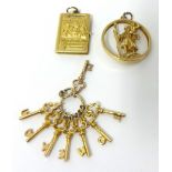 Three gold charms stamped 9K, approximately 12.4g