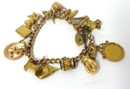 9ct gold charm bracelet with various charms including George V half sovereign 1913, 39.9g overall