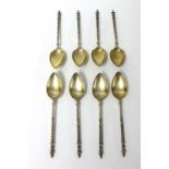 Eight silver spoons stamped .800 with lattice work handles and finials, approximately 76.5g