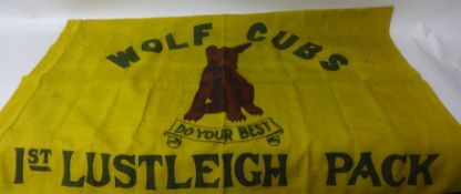 Two Signalling flags, Wolf Cubs flag Lustleigh pack, another flag and British Scout badges on