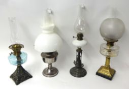 Four various Victorian and later oil lamps, tallest 63cm