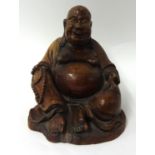 A Chinese carved hard wood Buddha, 21cm high