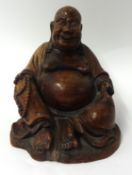 A Chinese carved hard wood Buddha, 21cm high