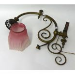 A Victorian ornate brass wall light bracket together with a pink coloured glass shade with crimped