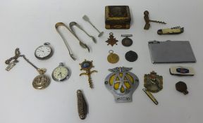 A collection of items including three pocket watches, four pen knives, car badge and medals