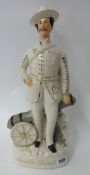 A Staffordshire flat back figure B-P, Standing in Front of a Cannon