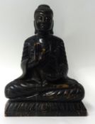 An old carved hard wood figure of a Buddha, probably coromandel wood, 35cm