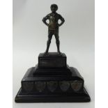 Brass standing Wolf Cub mounted on wooden trophy base with silver winners shields (The Wilson