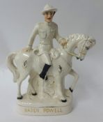 A Staffordshire flat back figure-B-P on Horseback, left hand holding horses mane (mainly white)