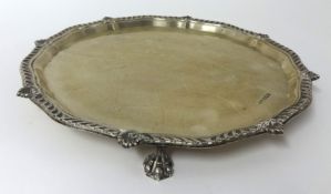 A silver salver with gadrooned border and claw feet, approx 16 oz