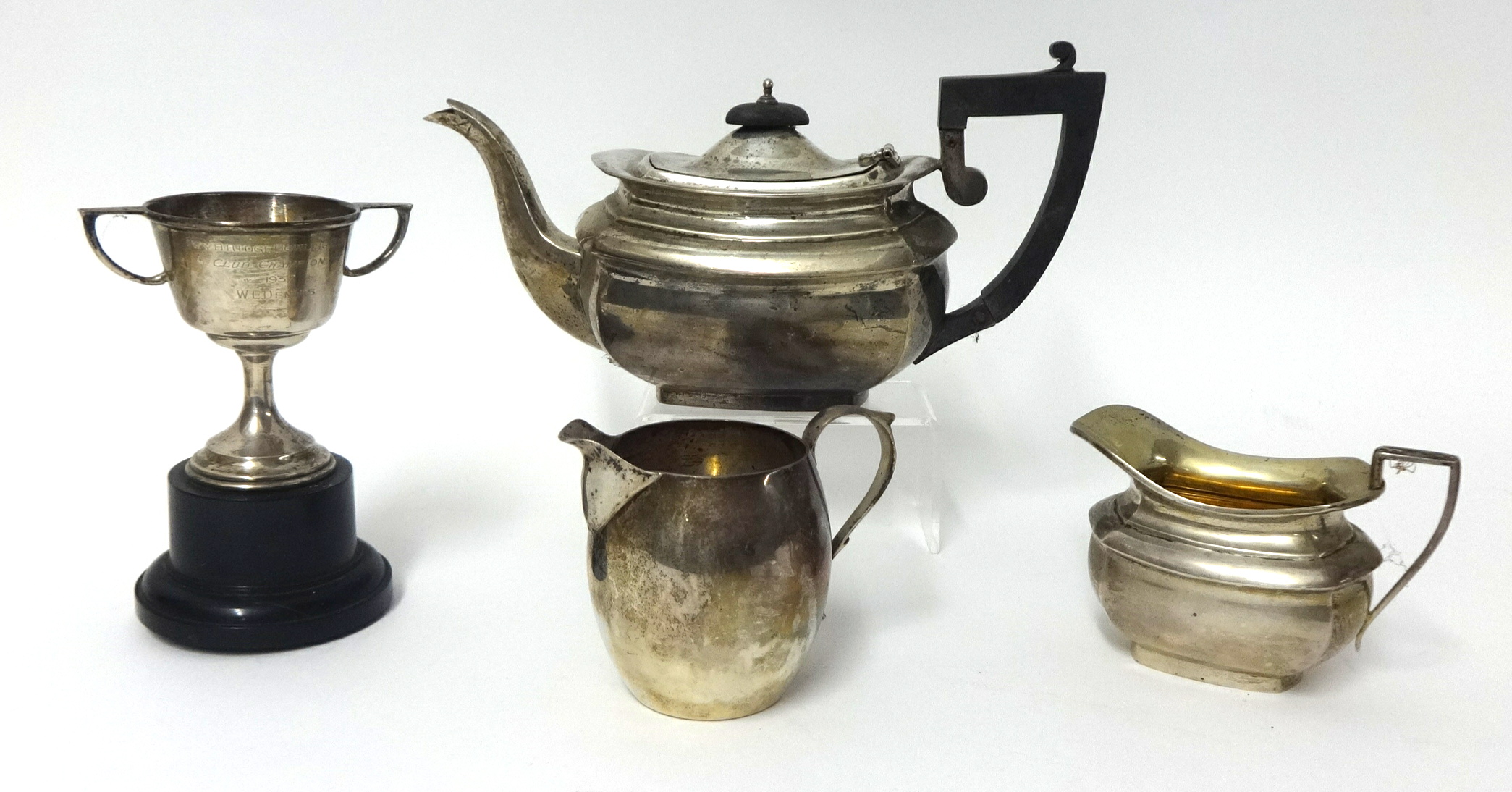 A silver tea pot of squat form, a similar cream jug and sucre, another cream jug and small cup