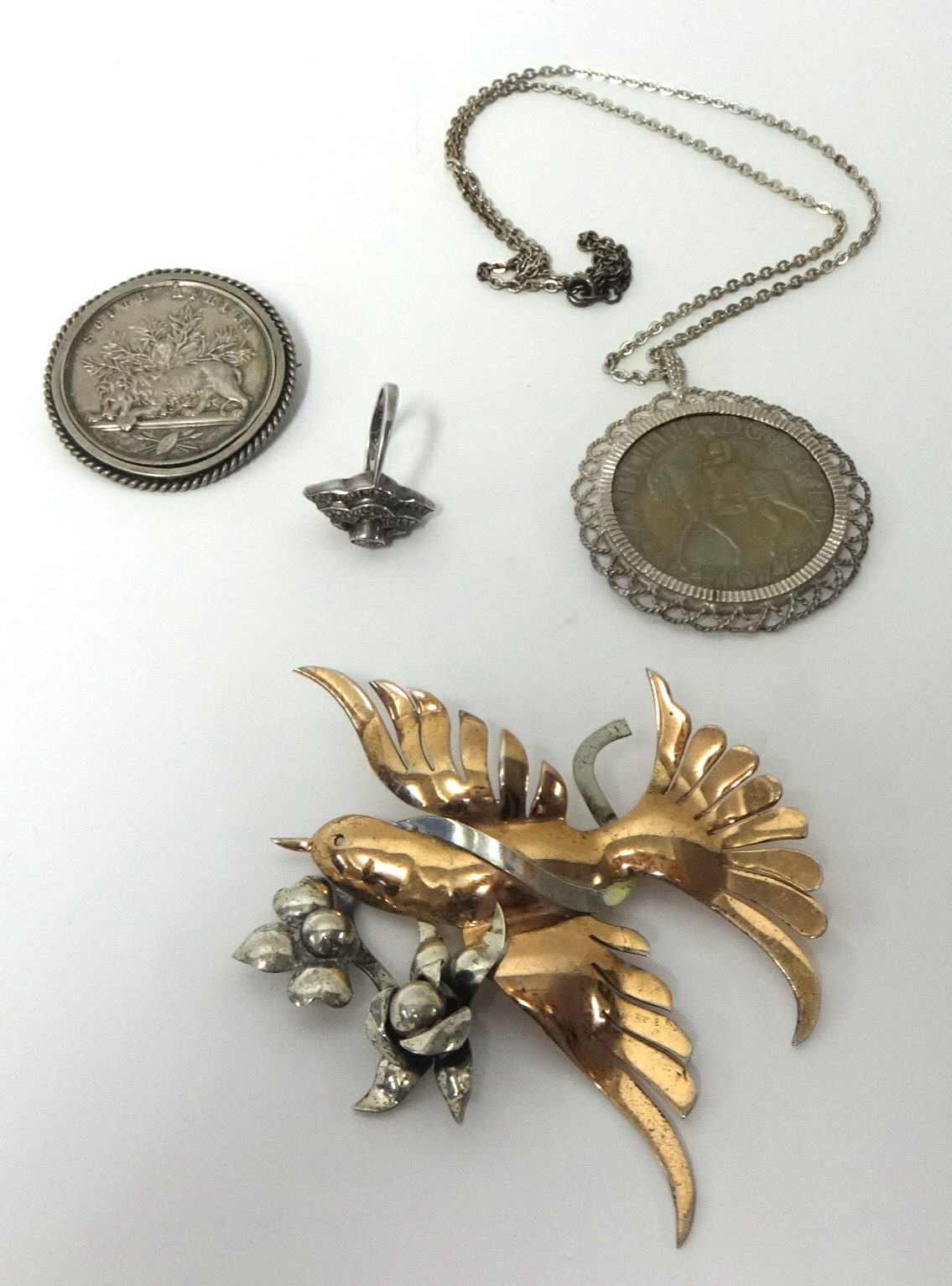 An unusual gilt metal contempory brooch in the form of a bird, dress ring, mounted South Africa