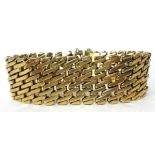 A one inch wide 9ct gold fancy bracelet, sponsors mark RJAT, circa 1960's approximately 67g with