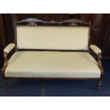An Edwardian settee of double chair back design with inlaid frame and white upholstery