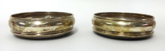 A pair of 19th century silver wine bottle coasters