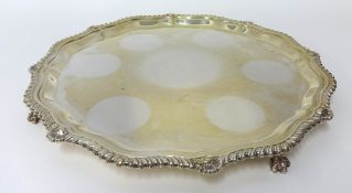 A modern silver salver with gadrooned and shell design border and shaped feet, circa 1927, 32cm,