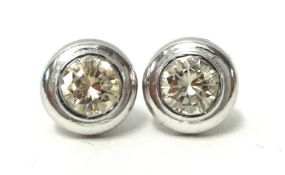A pair of diamond and white gold ear studs