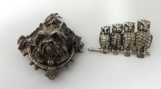 A white metal brooch formed as a terrier dog head with red glass eyes t/w a four owl bar brooch (2)