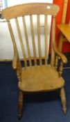 An old farmhouse elbow chair with elm seat and lathe back
