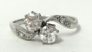 A platinum ring set with two round cut diamonds