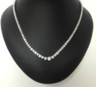 A fine diamond necklace, weighing approximately 11 carats, 44cm long set in white gold (129