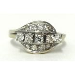 Five stone diamond ring set with a further arrangement of eight diamonds either side in white metal,