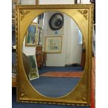 A reproduction large oval and gilt framed wall mirror 138cm x 107cm