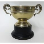 A silver twin handled trophy on wood socle base, inscribed, approx 10 oz