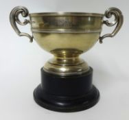 A silver twin handled trophy on wood socle base, inscribed, approx 10 oz