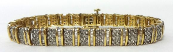 A gold and diamond bracelet set in 10K yellow gold, 18cm