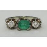 An antique emerald and diamond three stone ring size M set in white gold