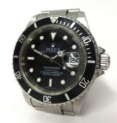 A Gents Rolex stainless steel Submariner wrist watch with original papers dating 2006, guarantee Ref